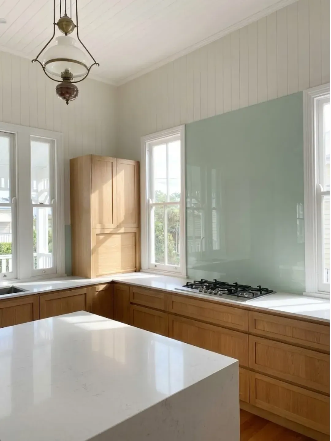 Seamless hygienic glass splashback installed in an Ascot kitchen renovation with modern finishes.